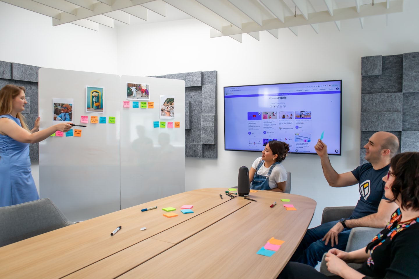 Colleagues brainstorm ideas with sticky notes on a whiteboard.